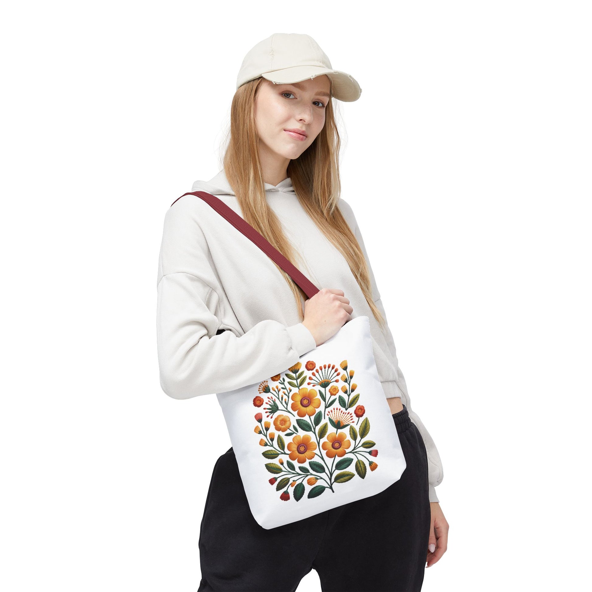Folk Art Floral Faux Embroidery Style Tote Bag features warm yellow and earth-toned floral designs with olive green leaves, embodying a relaxed, artistic vibe ideal for daily use by nature lovers and artists.