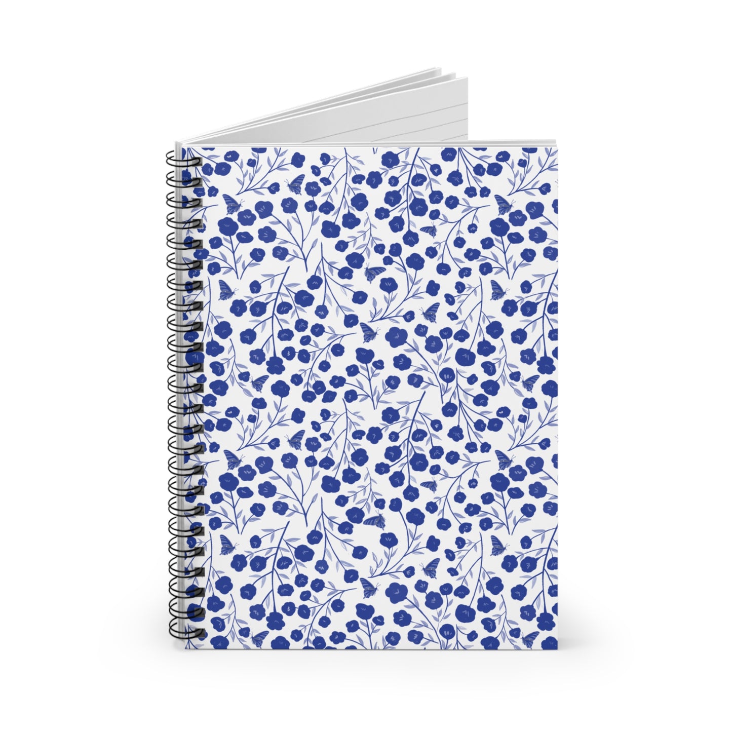 Floral Spiral Notebook with blue stylized flowers on a white cover, featuring durable metal binding and visible blank pages, ideal for creative expression and organization from FireBrook Designs.