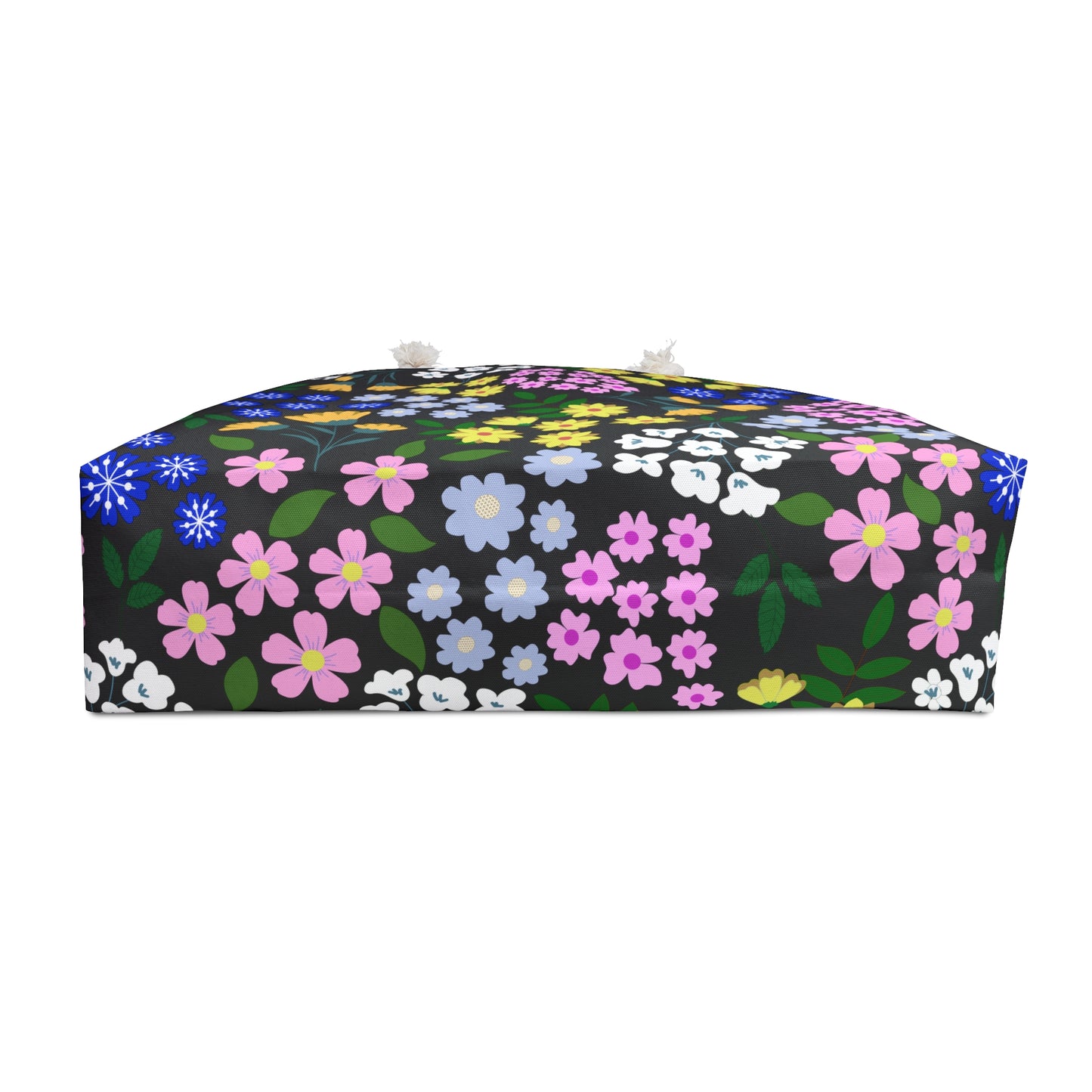 Weekender Bag featuring a decorative floor cushion design with a black fabric and vibrant stylized floral print, complemented by tassel details, embodying FireBrook Essentials' commitment to joyful, stylish travel accessories.