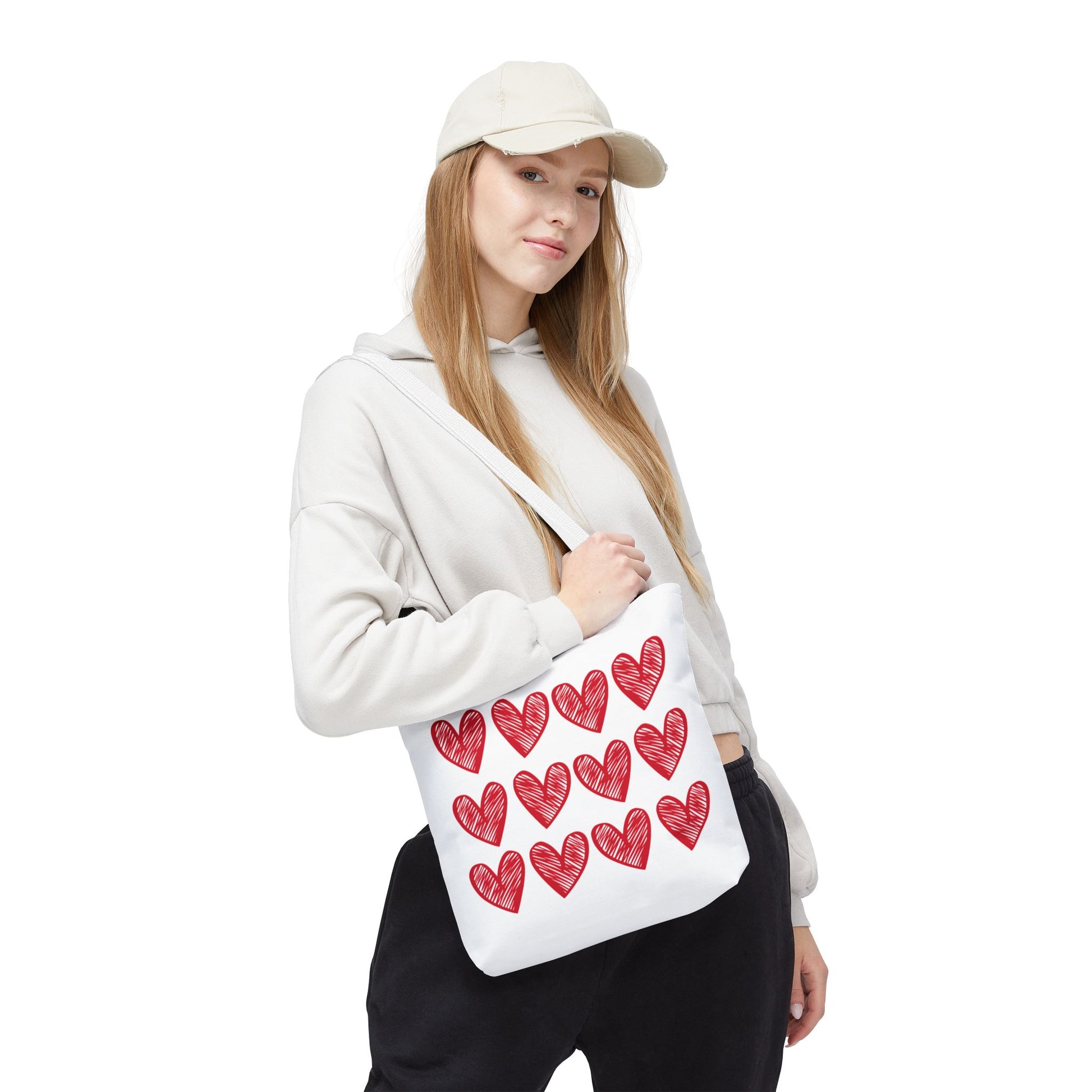 Hearts Tote Bag featuring a whimsical white design adorned with red hearts, perfect for quirky fashion lovers. Ideal for daily use, offering durability and style with reinforced handles for comfort.