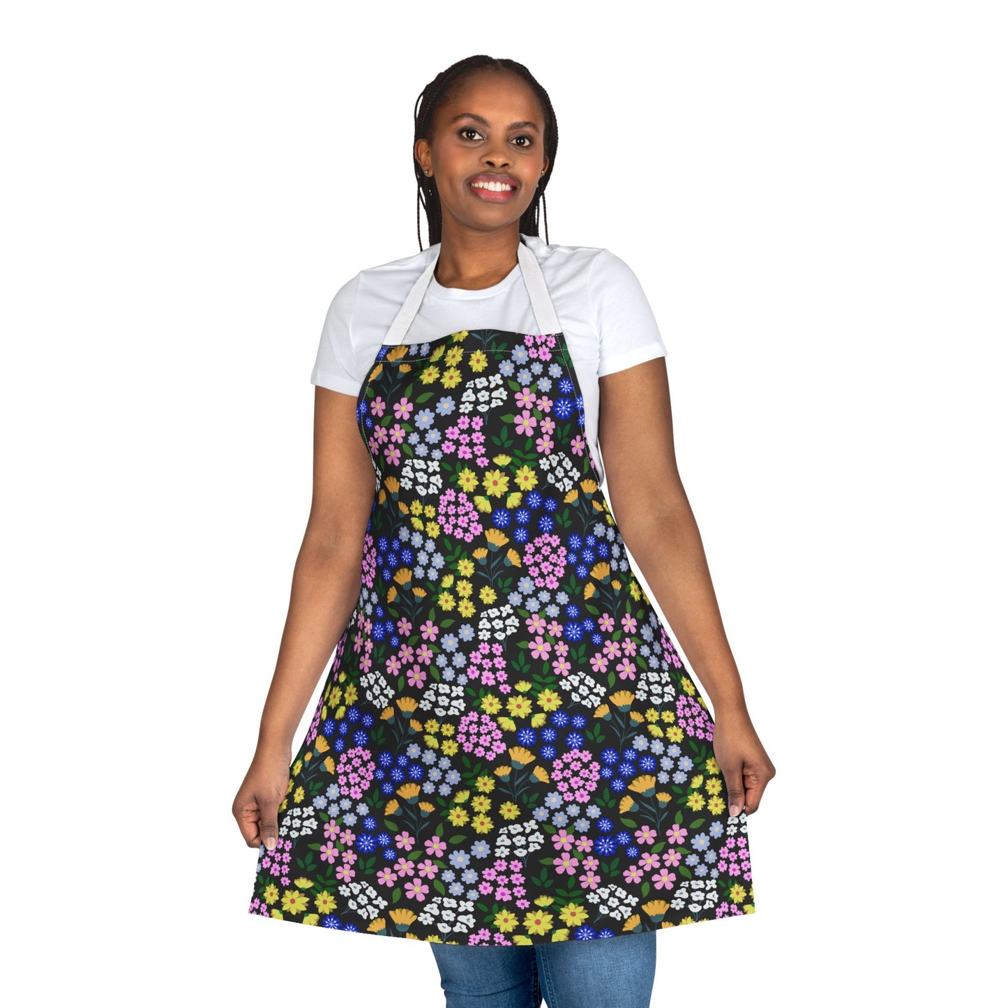 Person wearing Apron Floral Design with vibrant floral pattern over a white shirt and blue jeans, showcasing FireBrook Essentials' commitment to comfort and positivity through stylish, stain-free polyester canvas fabric.