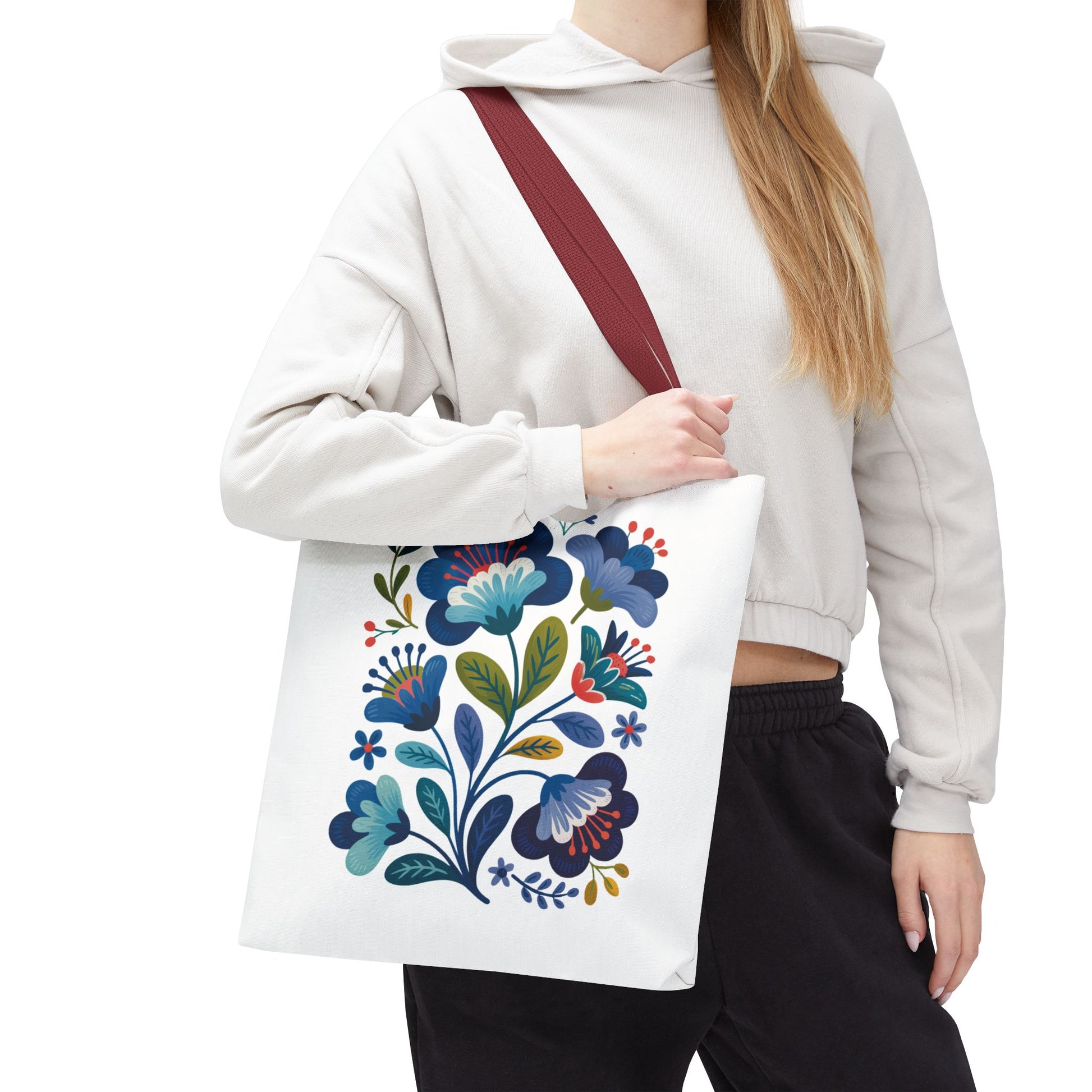 Vintage Folk Art Design Blue Floral Tote Bag featuring charming floral patterns, perfect for both everyday use and special occasions. Durable polyester body with reinforced handles, offering style and practicality in multiple sizes.