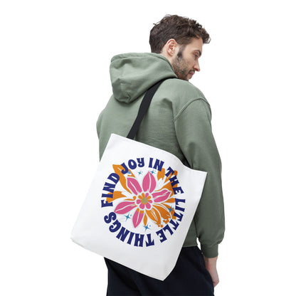 Man wearing green jacket with Find Joy in Little Things tote bag, featuring a flower design, over shoulder; embodies positivity and multifunctional use.