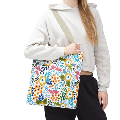 Floral Tote Bag featuring a vibrant floral print with mustard, coral, teal, navy, and green hues, perfect for adding a cheerful touch to summer outings, carried over the shoulder by a casually dressed person.