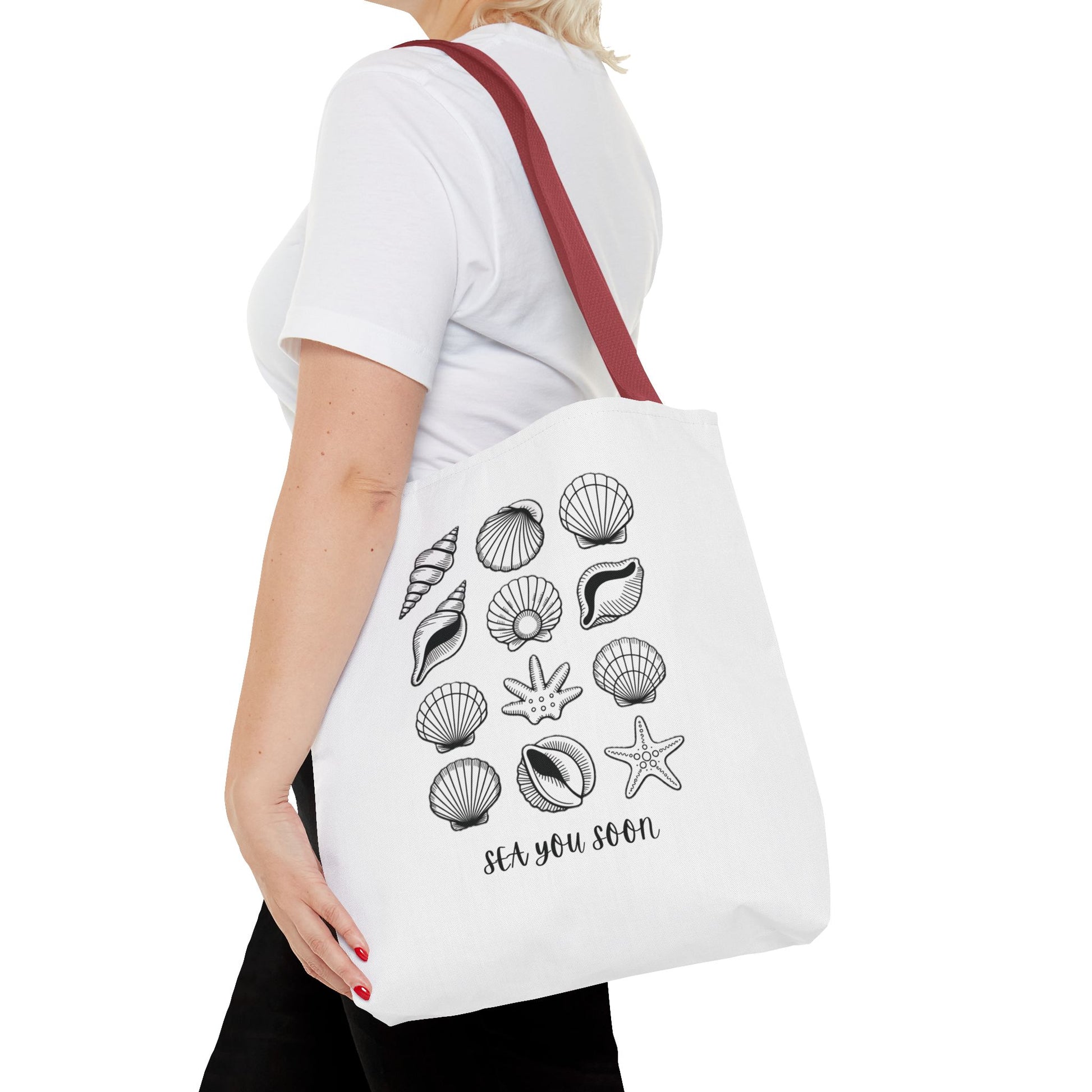 Sea Shells Tote Bag showcasing a nautical-themed design, ideal for beach trips. Made from durable polyester with reinforced stitching and boxed corners, it offers ample space for essentials, embodying FireBrook Essentials' joyful, practical style.