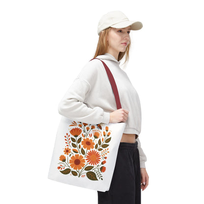 Folk Floral Tote Bag showcasing hand-drawn wildflowers in warm hues on a white background, exuding vibrant, traditional folk art. Ideal for nature lovers, perfectly blending style and practicality for daily use.