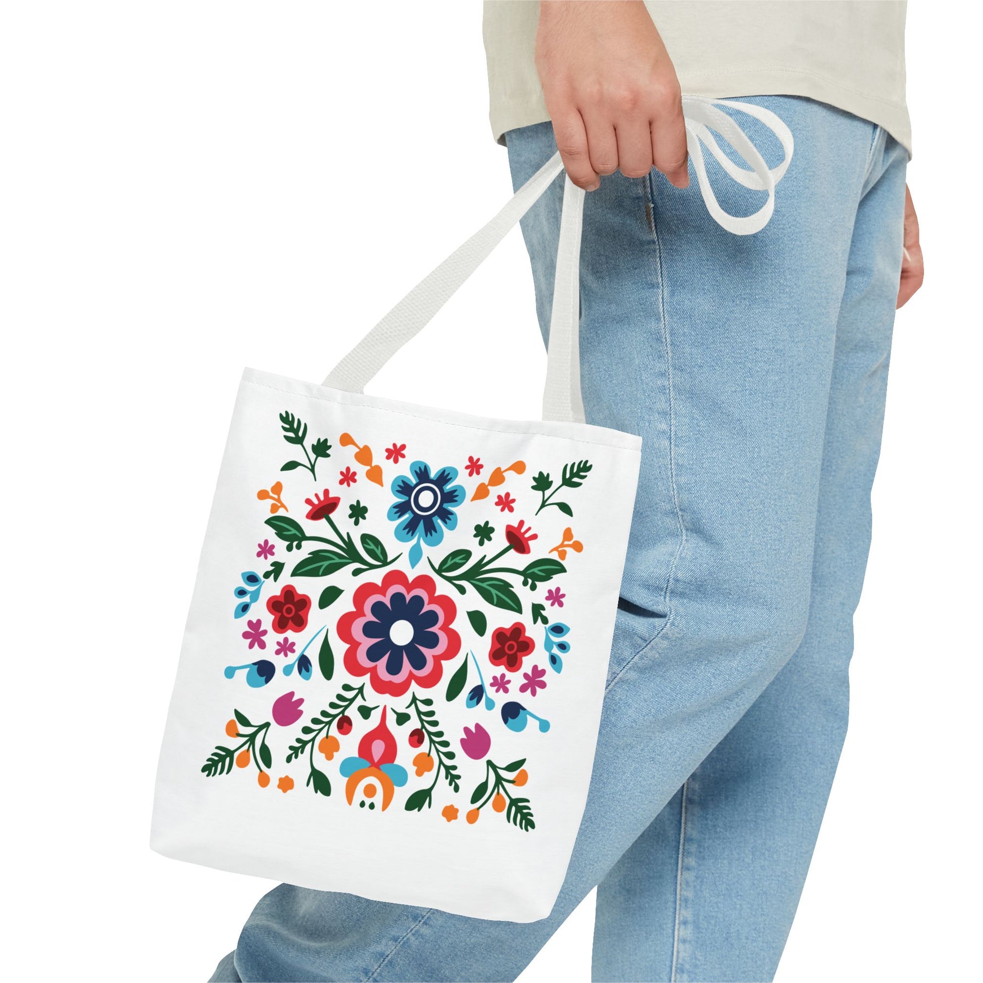 Person holding a Floral Tote Bag adorned with colorful flowers, showcasing its stylish design and practicality for daily use. Ideal for carrying essentials.