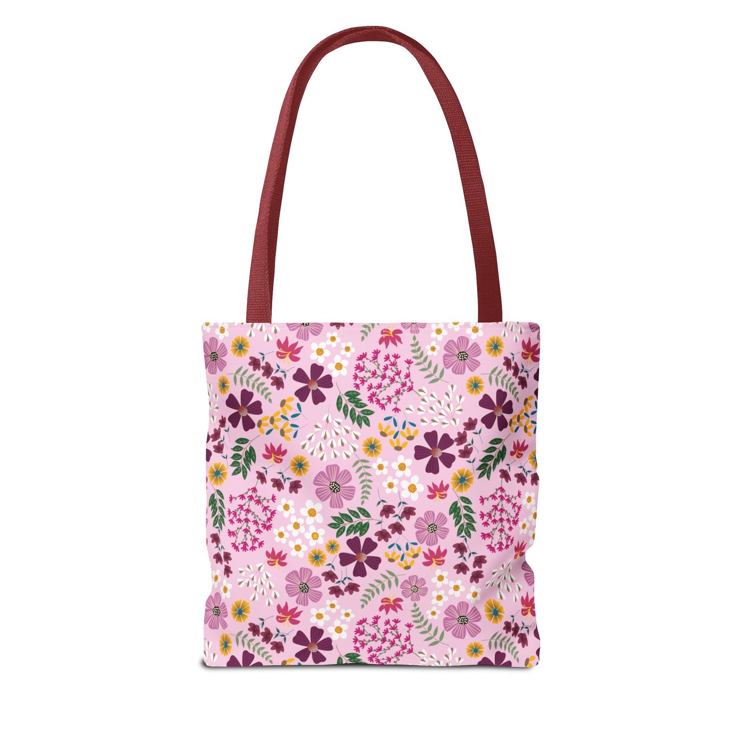 The Rose Garden Blush Tote Bag features burgundy-red handles and a pink floral-patterned body with purple, magenta, yellow, and white blossoms, embodying FireBrook Designs' commitment to stylish, durable everyday accessories.