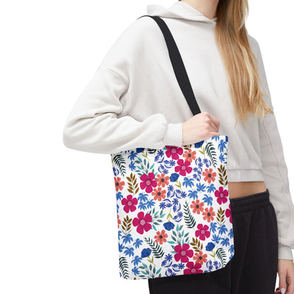 Floral Tote Bag over shoulder, showcasing vibrant pink, red, and blue blooms with green leaves, ideal for cheerful summer outings. Durable polyester construction with reinforced handles, perfect for joyful, stylish use.