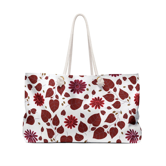 Weekender Bag with deep red and burgundy fall-themed leaves and flowers, featuring thick rope handles. Ideal for stylish travel, this spacious tote embodies FireBrook Designs' uplifting and joyful aesthetic.