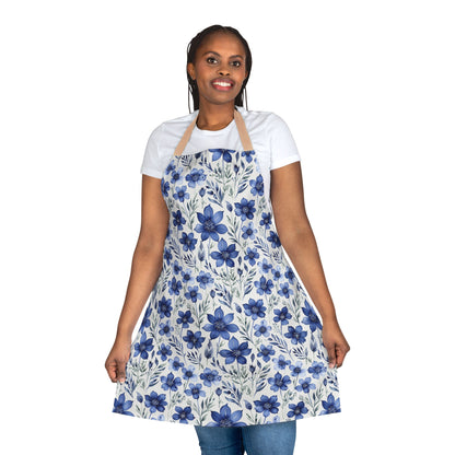 Apron, Blue Wildflower Pattern: A close-up of a smiling woman wearing a hand-painted indigo blue apron with a soft watercolor wildflower design, ideal for artistic and culinary enthusiasts.