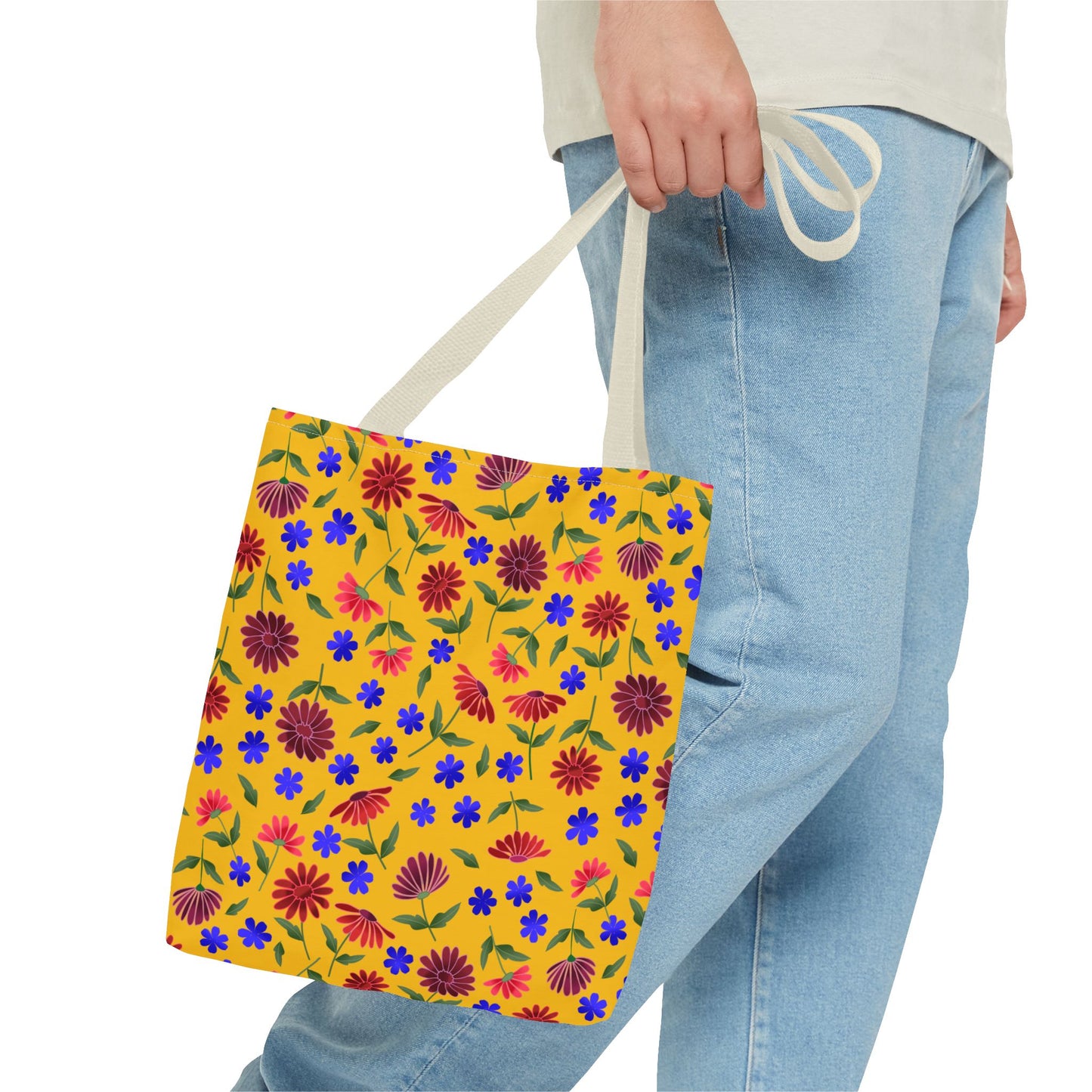 Golden Wildflower Tote Bag with bright mustard background features scattered floral print, held by natural straps, showcasing vibrant designs ideal for everyday use. Perfect for adding a joyful touch to daily errands.