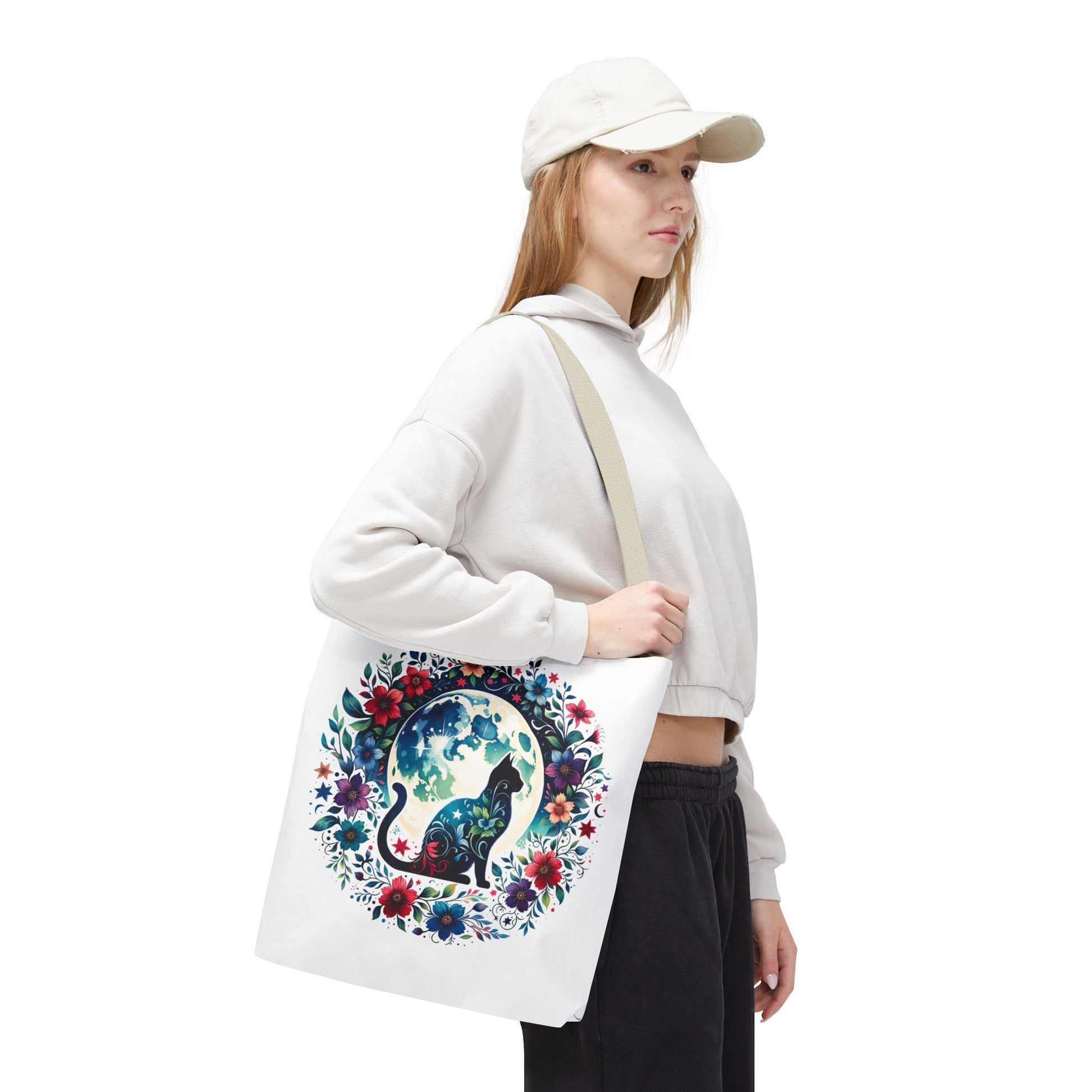 Lone Cat Under the Moon Tote Bag features a whimsical cat design, perfect for errands or beach trips. Durable polyester with reinforced handles, available in three sizes from FireBrook Essentials.