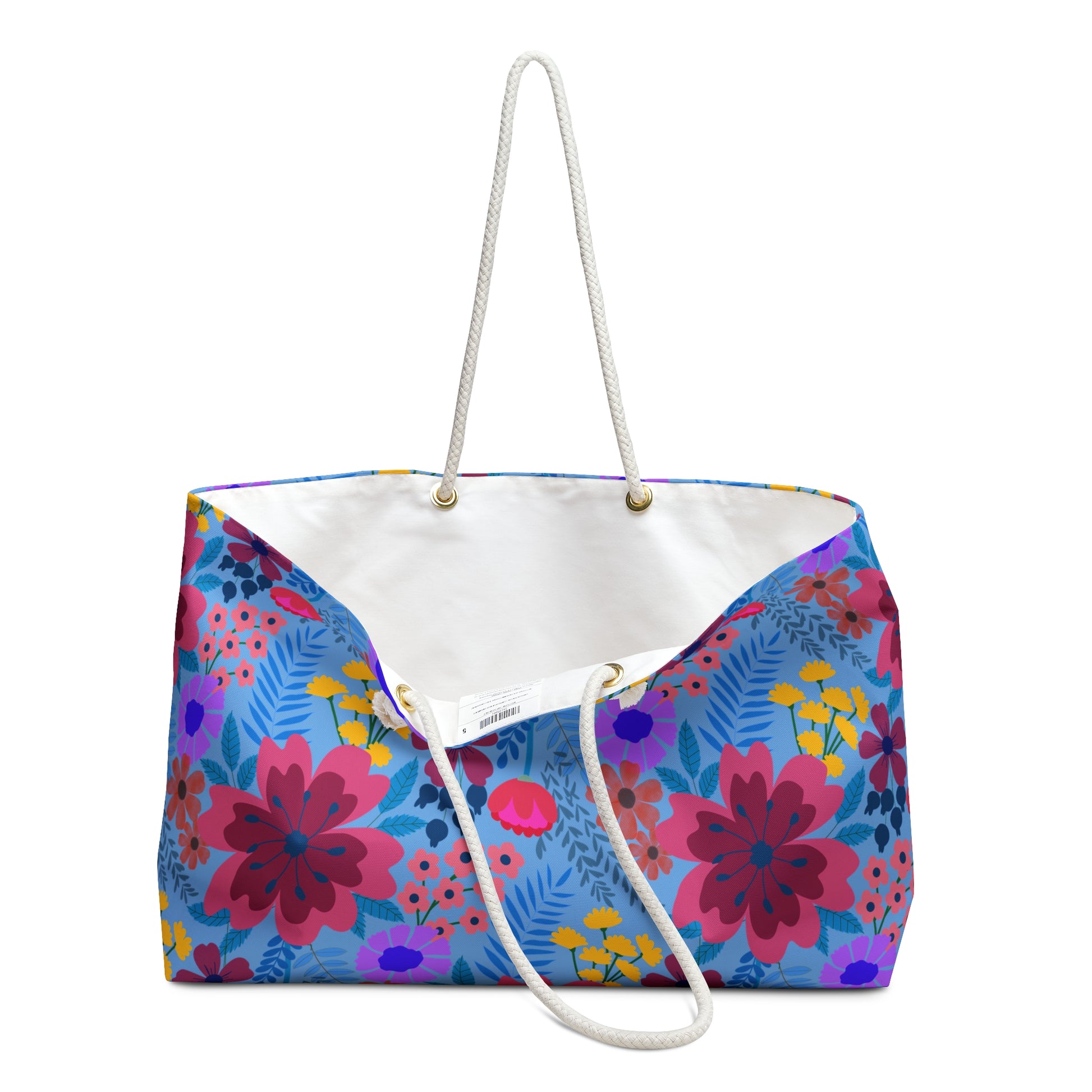 Weekender Bag with vibrant floral print and white rope handles, ideal for stylish travel. Features a spacious interior and T-bottom design, perfect for weekend getaways.