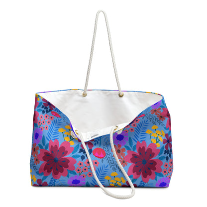 Weekender Bag with vibrant floral print and white rope handles, ideal for stylish travel. Features a spacious interior and T-bottom design, perfect for weekend getaways.