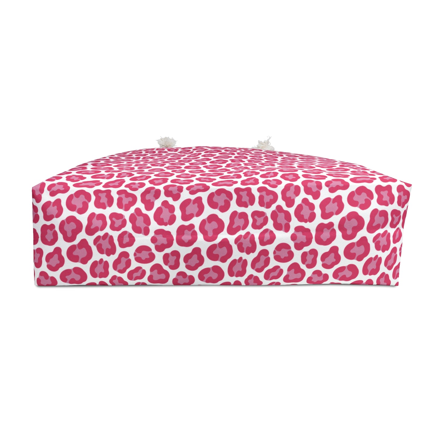 Cheetah Weekender Bag featuring a bold pink and white pattern, ideal for stylish travel. Equipped with cream-colored rope handles and a T-bottom design, perfect for adventurous getaways.