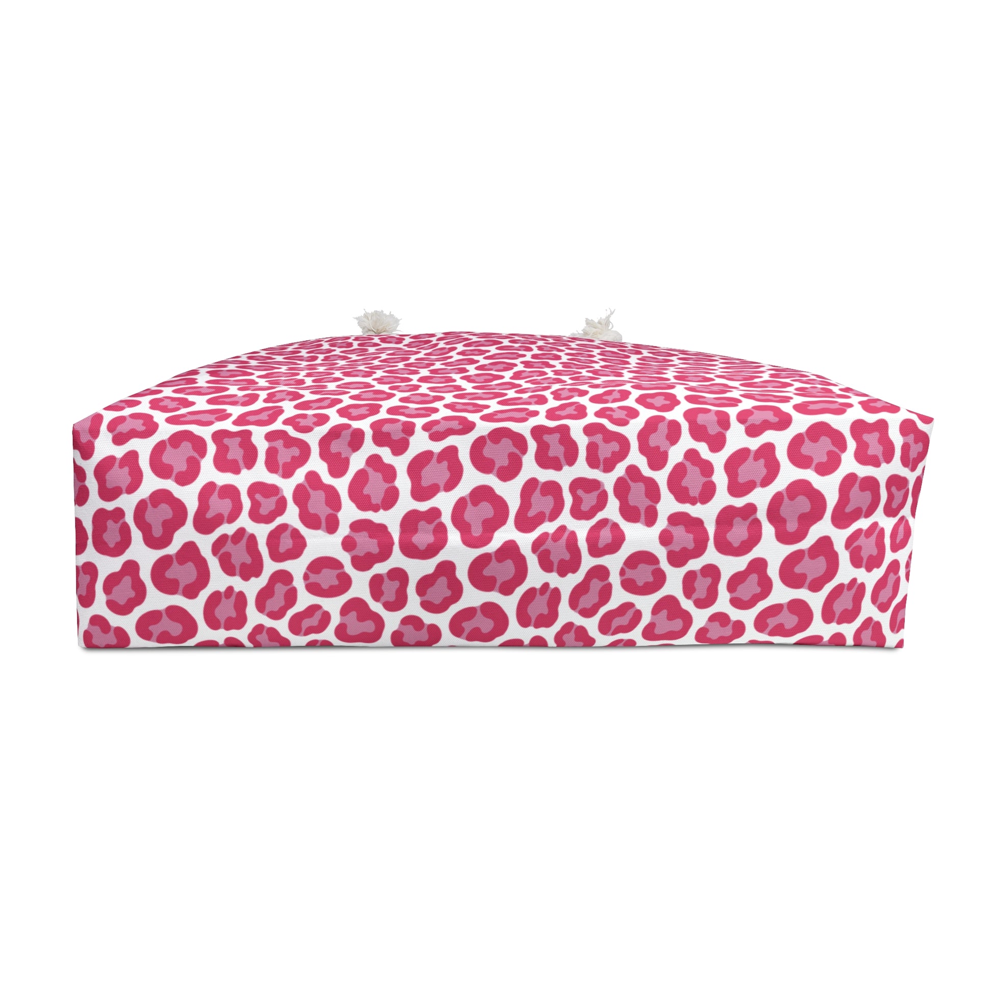Cheetah Weekender Bag featuring a bold pink and white pattern, ideal for stylish travel. Equipped with cream-colored rope handles and a T-bottom design, perfect for adventurous getaways.