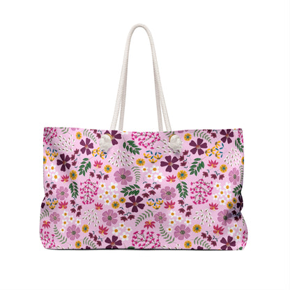 Weekender Bag with stylish thick white rope handles and a soft pink floral pattern featuring purple, yellow, and pink blossoms, ideal for stylish and joyful weekend getaways.