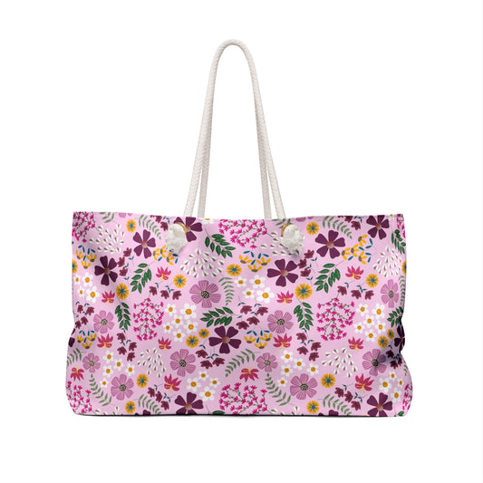 Weekender Bag with stylish thick white rope handles and a soft pink floral pattern featuring purple, yellow, and pink blossoms, ideal for stylish and joyful weekend getaways.
