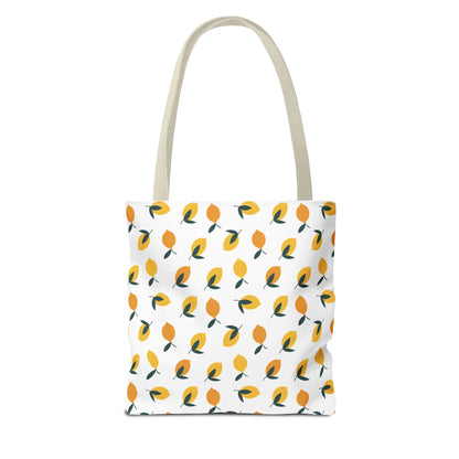 Lemon Drop Toss Tote Bag features a vibrant lemon pattern with green leaves on a white background, offering a refreshing, cheerful style perfect for summer outings and everyday use.