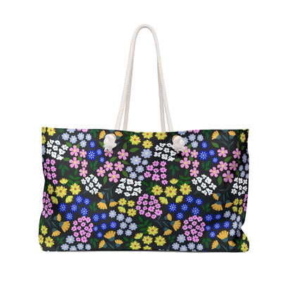 Weekender Bag with a vibrant floral pattern and white rope handles, designed for stylish travel. Perfect for weekend getaways, it features a spacious interior and durable, wrinkle-free polyester material.