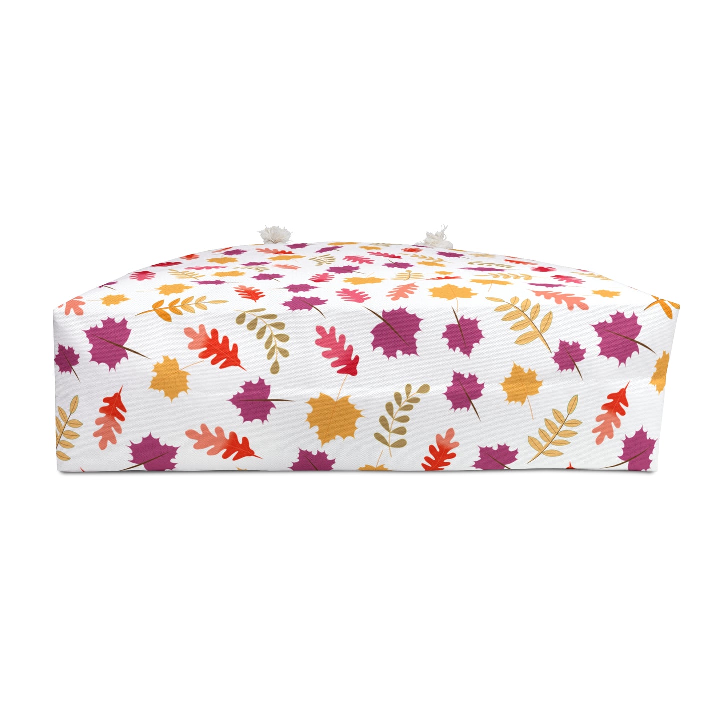 Weekender Bag featuring a vibrant red bouquet design on a low, rectangular floor pouf with autumn leaves pattern, perfect for stylish travel. Made from spun polyester with rope handles, embodying FireBrook Essentials' joyful designs.