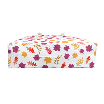 Weekender Bag featuring a vibrant red bouquet design on a low, rectangular floor pouf with autumn leaves pattern, perfect for stylish travel. Made from spun polyester with rope handles, embodying FireBrook Essentials' joyful designs.