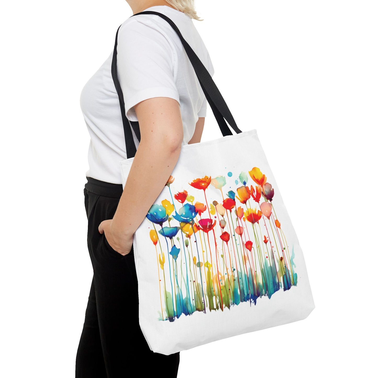 Woman holding a Watercolor Floral Tote Bag featuring a flower design, ideal for stylish, functional use in daily errands or outdoor activities.