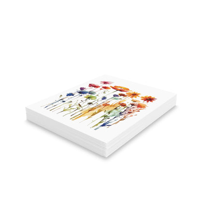 Wildflowers Greeting Cards — Pack of 8/16/24: A stack of square, white matte-finish cards featuring a vibrant watercolor wildflower design on top, ideal for thoughtful messages; includes matching envelopes.