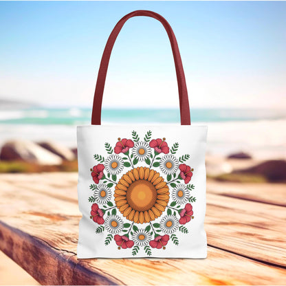 Mandala Sunflowers & Daisies Tote Bag features a vibrant mandala-style floral design, perfect for summer outings. The white canvas bag with burgundy handles embodies boho-chic style and practicality.