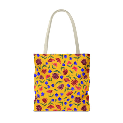 Golden Wildflower Tote Bag with vibrant yellow canvas, featuring red and maroon daisies, blue flowers, and green leaves. Natural straps complement this lively, spacious bag, embodying FireBrook Designs' cheerful, practical style.