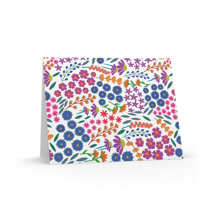 Floral Greeting Cards — Pack of 8/16/24, showcasing a vibrant floral pattern on the front, stand partially open. Each card includes a matching envelope, perfect for expressing gratitude or well-wishes.