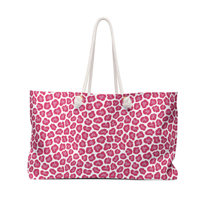 Cheetah Weekender Bag with bold pink and white leopard print, featuring cream rope handles and a durable cream interior lining, designed for stylish and adventurous travel enthusiasts.