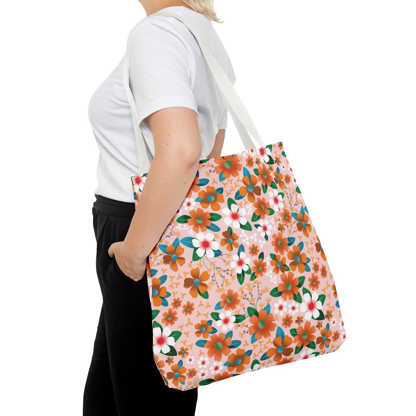 Person with a Peach Poppy Grove Tote Bag featuring vibrant floral patterns in orange, white, and teal, ideal for summer outings. The bag's durable construction and stylish design align with FireBrook Designs' uplifting aesthetic.