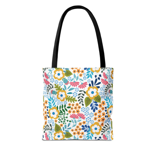 Floral Tote Bag with black straps, featuring a vibrant floral pattern in yellow, pink, blue, and orange on a white background, embodies FireBrook Designs' cheerful style, perfect for summer outings.