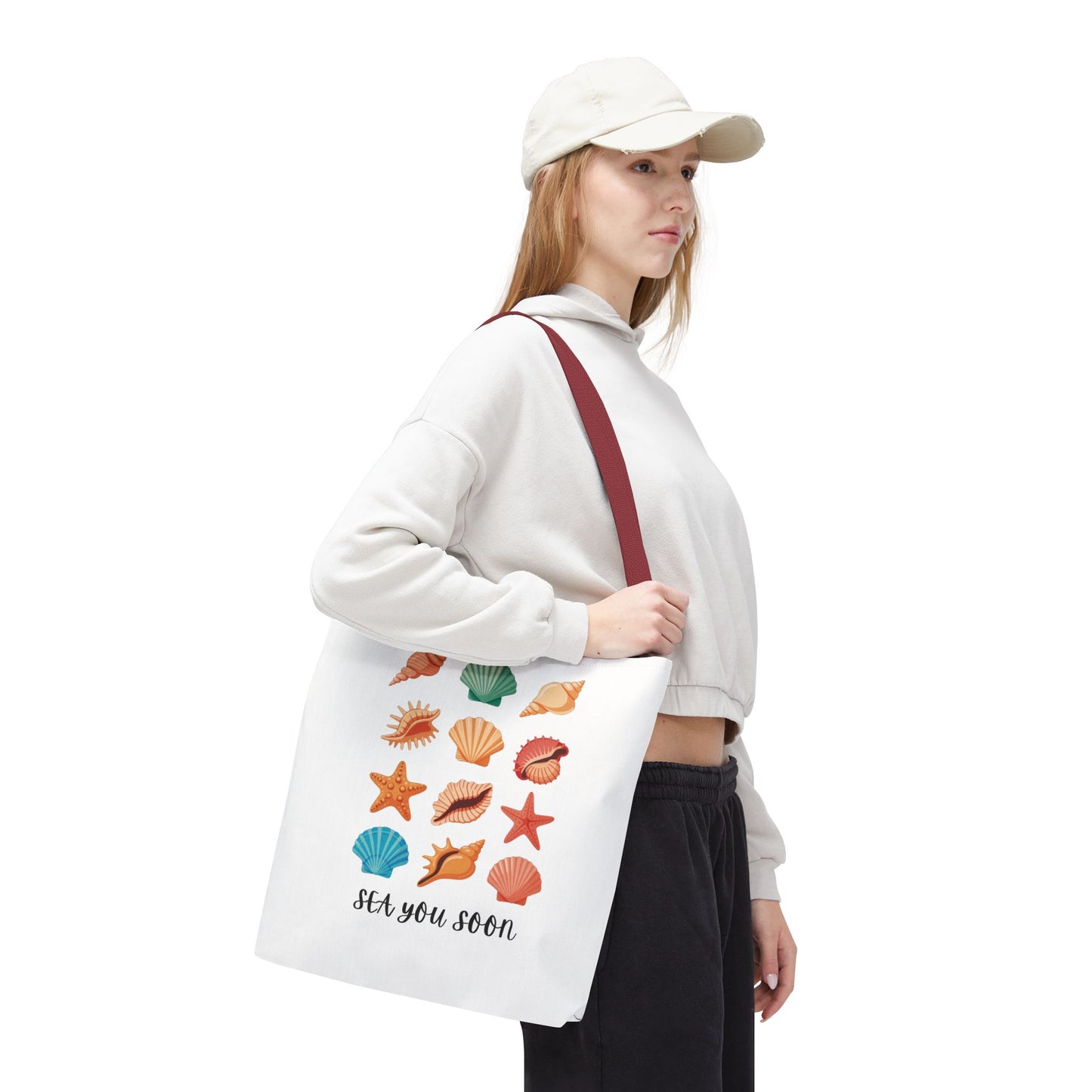 Sea You Soon Sea Shells Tote Bag featuring seashell designs, ideal for beach outings. Durable polyester with reinforced handles and boxed corners. Perfect for ocean lovers seeking a summery, coastal accessory.