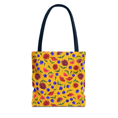 Golden Wildflower Tote Bag with navy handles features a vibrant yellow background adorned with red and pink daisies, blue flowers, and green leaves, embodying FireBrook Designs' joyous, practical style.