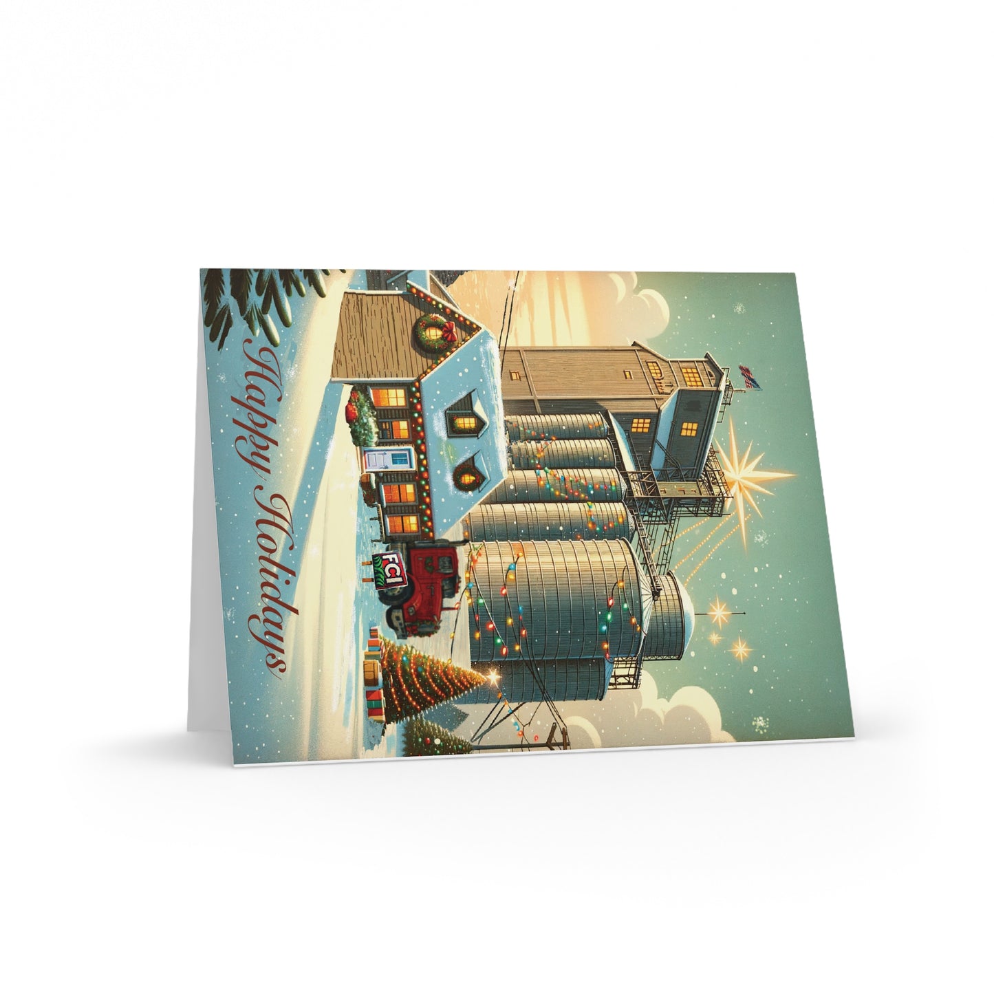Greeting Cards — Mill - Pack of 8/16/24: Folded card featuring a snowy farm scene with a decorated tree and gifts, mill house, silos with lights, and a red truck, inscribed Happy Holidays.