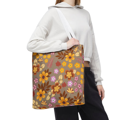 A person carries the Harvest Brown Bloom Tote Bag, showcasing its autumnal floral pattern and white strap, ideal for joyful summer outings, embodying FireBrook Essentials' cheerful and practical design ethos.