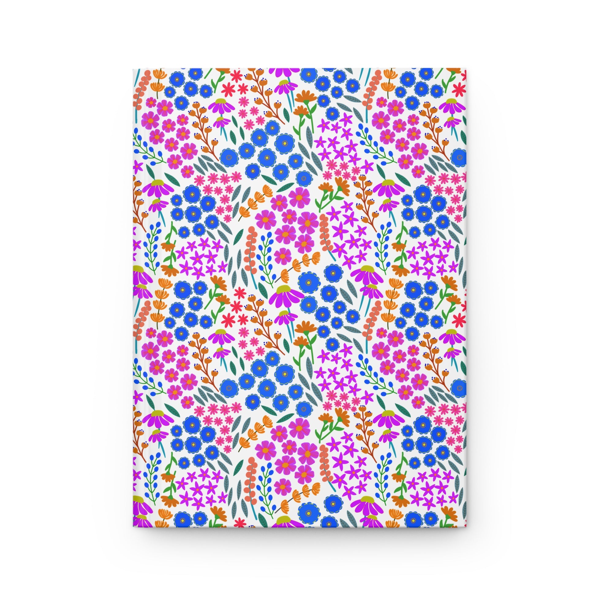 HARDCOVER JOURNAL, MATTE, RULED, 5X7, SEWN BIND, CLEAN-TEAR PAGES – WILDFLOWER PARADE features a vibrant floral design with clusters of blue, pink, and magenta flowers, embodying FireBrook Designs' uplifting style.