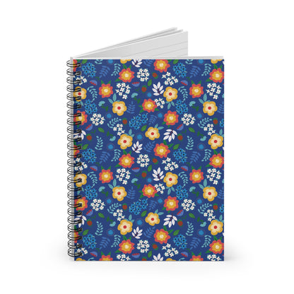 Floral Spiral Notebook with vibrant floral pattern on deep blue cover, partly open to reveal pages. Perfect for creative note-taking, reflecting FireBrook Designs' ethos of style and functionality.