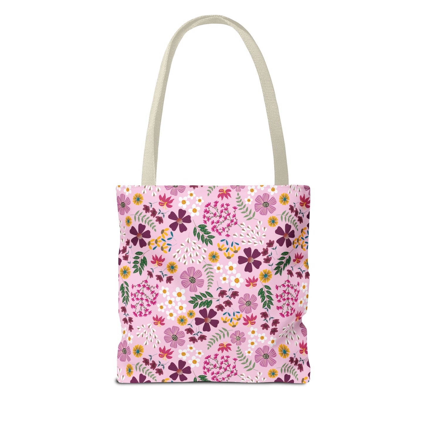 Floral Tote Bag showcasing a vibrant floral pattern with purples, pinks, and yellows on a pink canvas, featuring natural beige straps. Ideal for daily essentials, combining style and durability.