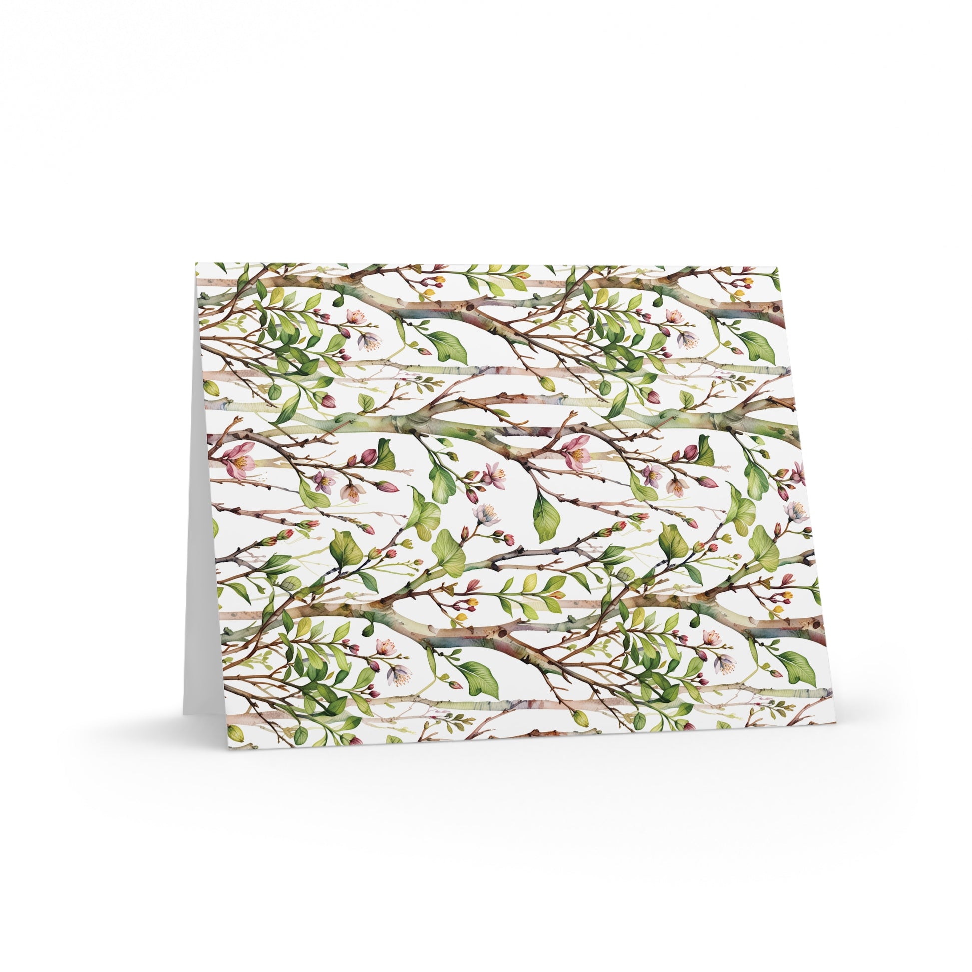 Greeting Cards — Pack of 8/16/24 featuring a delicate watercolor pattern of tree branches, green leaves, and pink blossoms on a matte-finish card, ideal for joyful, personal messages.