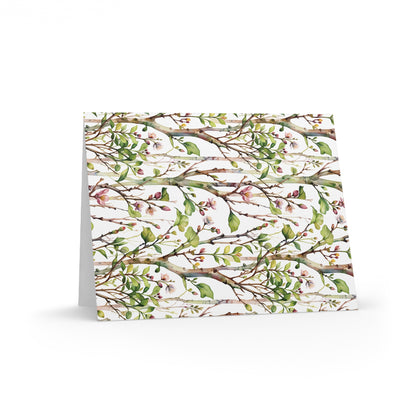 Greeting Cards — Pack of 8/16/24 featuring a delicate watercolor pattern of tree branches, green leaves, and pink blossoms on a matte-finish card, ideal for joyful, personal messages.