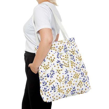 Floral Tote Bag featuring a white canvas with deep blue and mustard-yellow botanical prints, carried by a woman. Ideal for joyful summer outings, embodying FireBrook Designs’ uplifting and stylish essence.