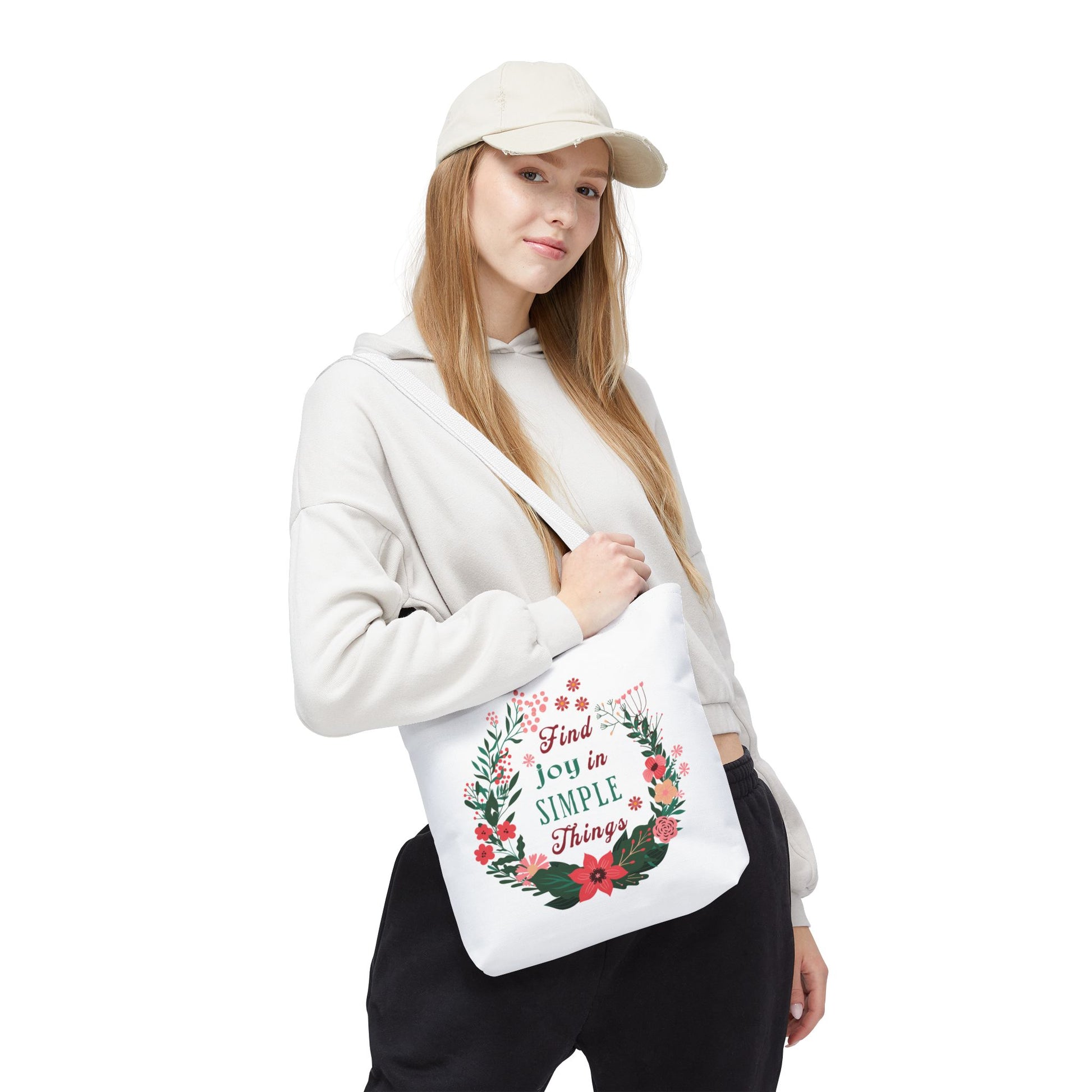 Woman holds Find Joy in Simple Things tote bag featuring a watercolor floral design, ideal for errands and travel, from FireBrook Essentials.