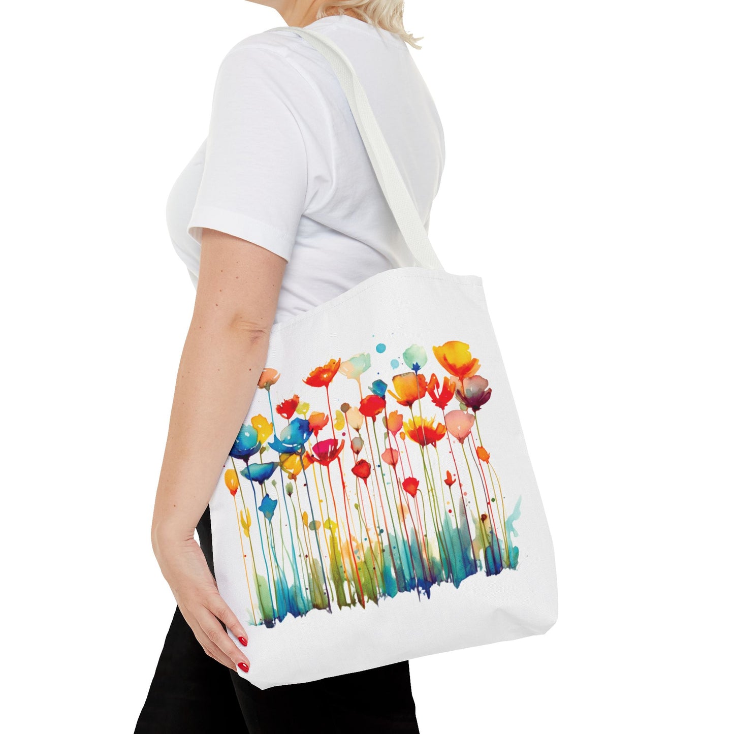 Woman holding a Watercolor Floral Tote Bag adorned with a vibrant flower design, highlighting its stylish and functional appeal.