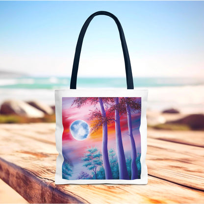 Moonlit Forest Tote Bag showcasing a mystical full moon scene with towering trees against a dramatic sunset sky, perfect for art and nature lovers seeking a stylish, durable accessory for everyday use.