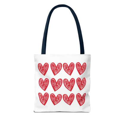 Hearts Tote Bag by FireBrook Designs, featuring a white body adorned with red hearts. Ideal for adding a playful touch to any outfit, it offers reinforced handles and boxed corners for durability and space.