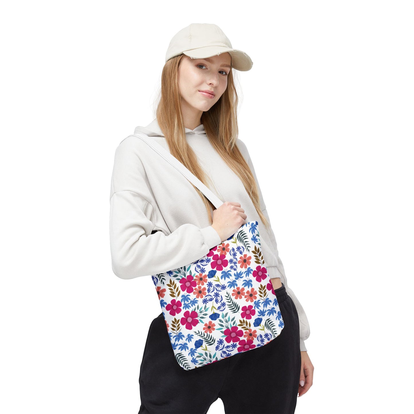 Young woman models the Confetti Wildflower Tote Bag, showcasing its vibrant floral pattern. This stylish, durable bag suits summer outings, aligning with FireBrook Designs’ joyful, uplifting aesthetic.